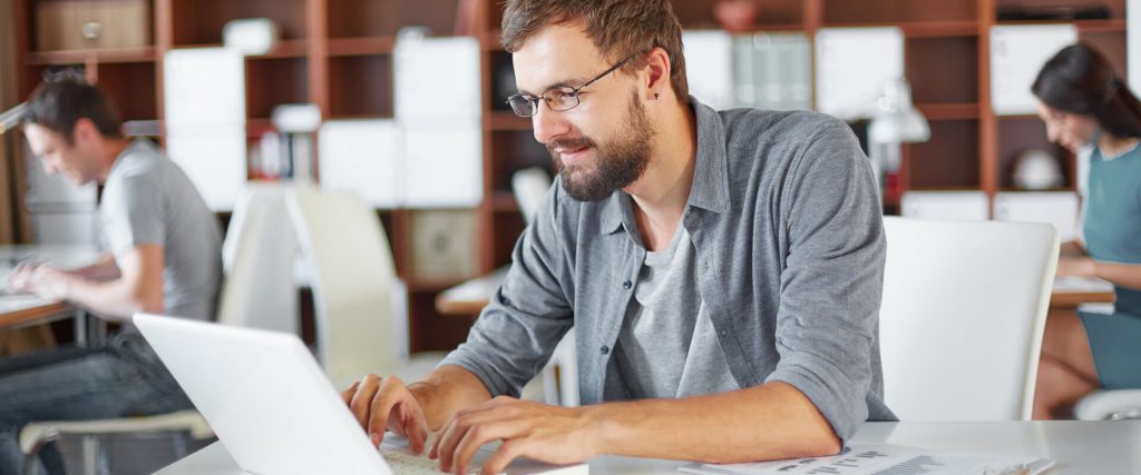 a white man using his laptop