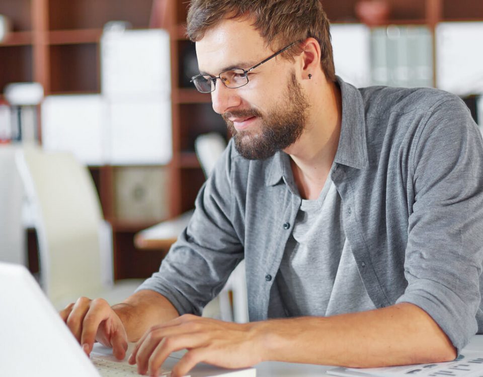 a white man using his laptop